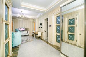 a living room with a table and a couch at Kolorit Modern Apartment in Baku