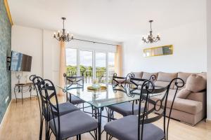 a dining room and living room with a glass table and chairs at Ferrera Soul 2a in Felanitx