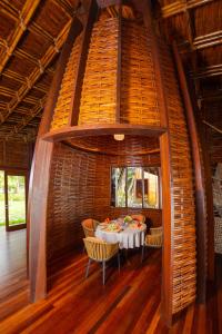 a room with a table and chairs in a building at Furaveri Maldives - COMPLIMENTARY ROUND-TRIP SEAPLANE TRANSFER FOR TWO FOR A MINIMUM OF 5 NIGHTS OR MORE FOR STAYS 1ST MAY 2026 TO 23RD DECEMBER 2026 in Raa Atoll