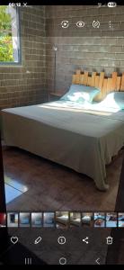 a bedroom with a large bed in a brick wall at Caslune in El Bidha