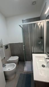 a bathroom with a shower and a toilet and a sink at La Casa di Stela 2 in Terni +7 photos