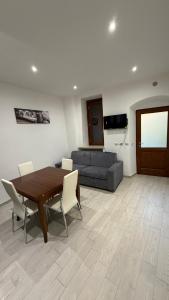 a living room with a wooden table and a couch at La Casa di Stela 2 in Terni