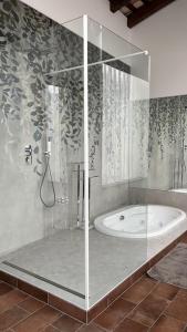 a bathroom with a shower with a bath tub at Antica serra in Buttrio