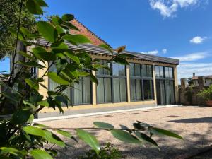 a building with glass windows and a roof at Antica serra in Buttrio