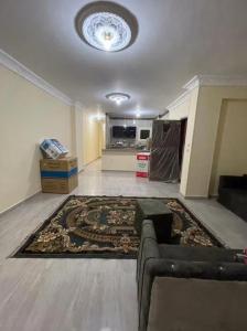 a living room with a couch and a rug at Newytr home in Kafr al Ishārah