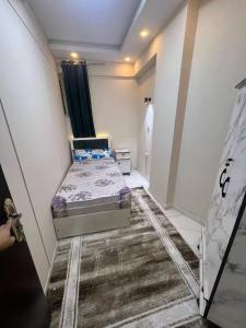 a small bedroom with a bed in a room at Newytr home in Kafr al Ishārah
