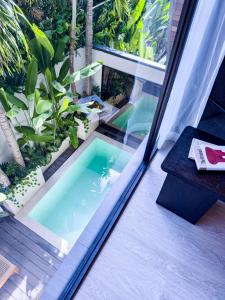 a plunge pool on a balcony with plants at Superior Luxury Loft with Working Desk, Instagramable Pool in Kerobokan