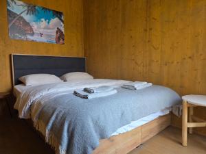a bedroom with a bed with towels on it at Villa Beach Charly in Tisno