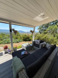 a couch on a porch with a view at Szarvas Vendégház in Zebegény