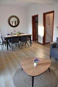 a living room with a table and a blue couch at Sxoleio Apartment in Kamariotissa