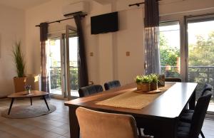 a dining room with a table and chairs at Sxoleio Apartment in Kamariotissa