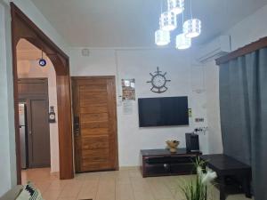 a living room with a flat screen tv on a wall at Blue bay in Blue Bay