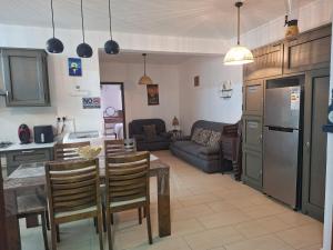 a kitchen and living room with a table and chairs at Blue bay in Blue Bay