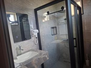 a bathroom with a sink and a glass shower at Blue bay in Blue Bay +9 photos