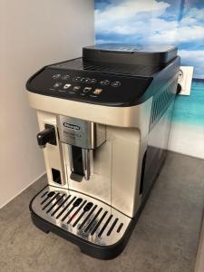 a black and silver coffee maker sitting on a counter at Lazurowy Brzeg in Przejma Wielka