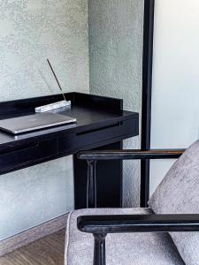 a black desk with a laptop and a chair at Superior Luxury Loft with Working Desk, Instagramable Pool in Kerobokan +288 photos