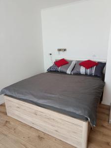a bed with a wooden frame in a bedroom at Apartmán Comfort in Trenčín