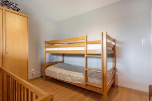 two bunk beds in a room with a staircase at Bungalow Windsbraut in Norddeich