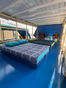 a large bed in a tent on a boat at Kelotok Orangutan Tanjung Puting in Kumai