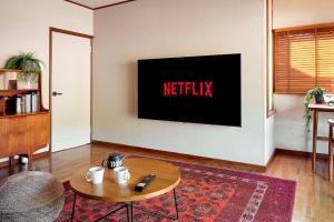 a living room with a tv with the netflix sign on the wall at Nikko Botan - 3 Min Walk from JR Nikko Station in Nikko +75 photos
