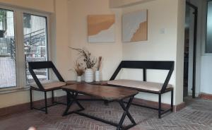 a living room with a table and two chairs at Bhurban Valley Cottages 3 in Bhurban