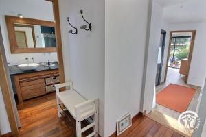 a bathroom with a sink and a mirror at Le bigorneau in Trégastel +58 photos