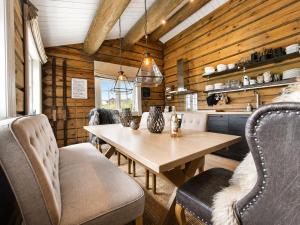 a wooden dining room with a wooden table and chairs at Dream mountain cabin with jacuzzi and views in Gol
