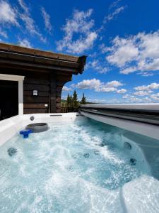 a hot tub on the roof of a house at Dream mountain cabin with jacuzzi and views in Gol