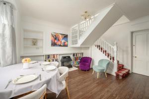 a white dining room with a table and chairs at Bosta Guest House - Private Rooms - Inverness in Inverness