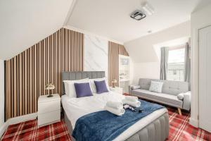 a bedroom with a bed and a couch at Bosta Guest House - Private Rooms - Inverness in Inverness