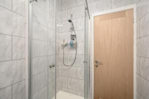 a bathroom with a shower with a glass door at Bosta Guest House - Private Rooms - Inverness in Inverness +65 photos