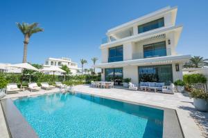 an image of a villa with a swimming pool at Palace Beach Resort in El Alamein