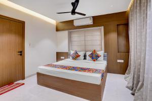 a bedroom with a large bed in a room at FabHotel Vaishnav Bairagi in Nashik +20 photos