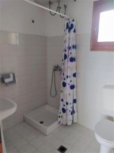 a bathroom with a shower curtain and a toilet at Vigla in Spartià +51 photos