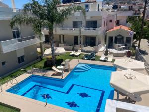 an overhead view of a swimming pool next to a building at Sirena Apartments in Agia Pelagia