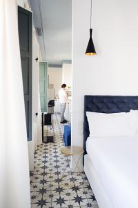 a bedroom with a bed and a table at Casa Alberola Apartments in Alicante +61 photos