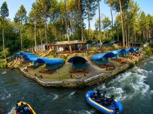 a group of people on rafts in the water at a river at Batupineus Riverside in Palayangan +47 photos