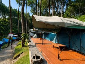 a large tent sitting on top of a wooden deck at Batupineus Riverside in Palayangan