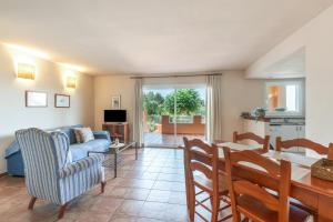 a living room with a couch and a table at Son Bou Pool and Sea in Son Bou