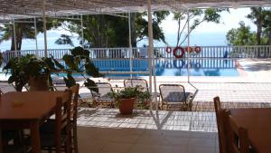 a patio with a table and chairs and a pool at Vigla in Spartià