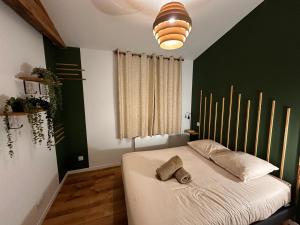 a bedroom with a bed with a hat on it at White housse - cabane - Sèvre Niortaise in Niort