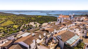 an aerial view of a village with houses and a river at Casa Almaraz in Reguengos de Monsaraz