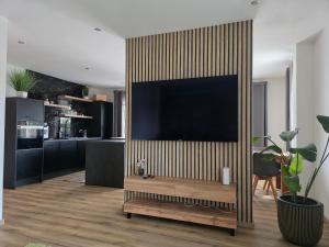 a living room with a large television on a wall at Ferienwohnung Engel in Grebenstein