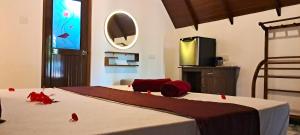 a bedroom with a bed with red peppers on it at Sigiri Enaya Cottage in Sigiriya