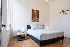 a bedroom with a bed with a painting on the wall at Zwaluwenburg 4 in 't Harde +59 photos