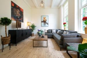 a living room with a couch and a table at Zwaluwenburg 4 in 't Harde