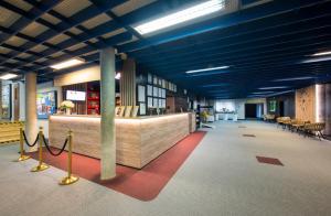 a large lobby with blue ceilings and a waiting area at Hotel SOREA ĽUBOVŇA in Stará Ľubovňa