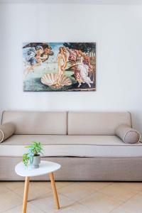 a living room with a couch with a painting on the wall at Corfu Dream Holidays Villas in Glyfada