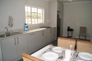 a kitchen with a table with two plates on it at Chalet Steenbok in Ladismith