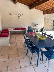a dining room with a blue table and chairs at Mas Daudé in Valleraugue +38 photos